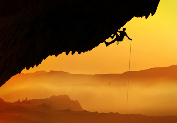 Alpinist - Silhouette at dawn during a dangerous pitch